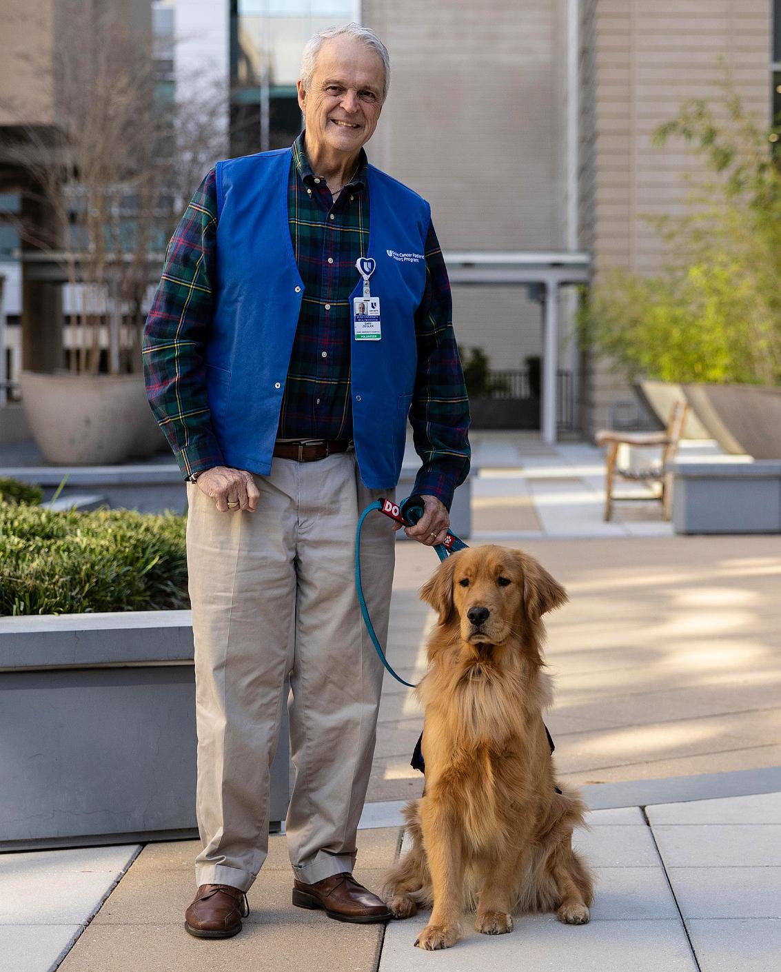 Gary Ziegler is the owner of and handler for Jerry, the Pets at Duke therapy dog for staff members. Photo by Travis Stanley